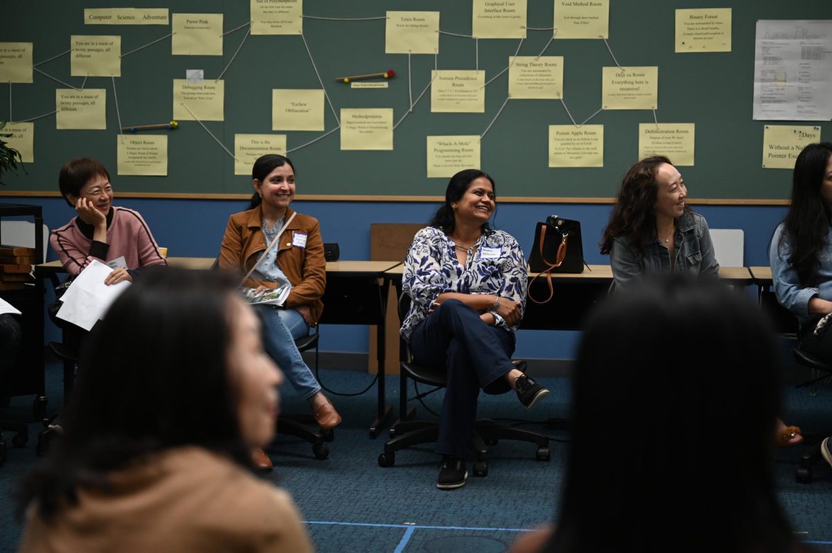 Parents laugh at a joke told by computer science teacher Swati Mittal. Mittal explained the curriculum for AP Computer Science A and told stories about the students.