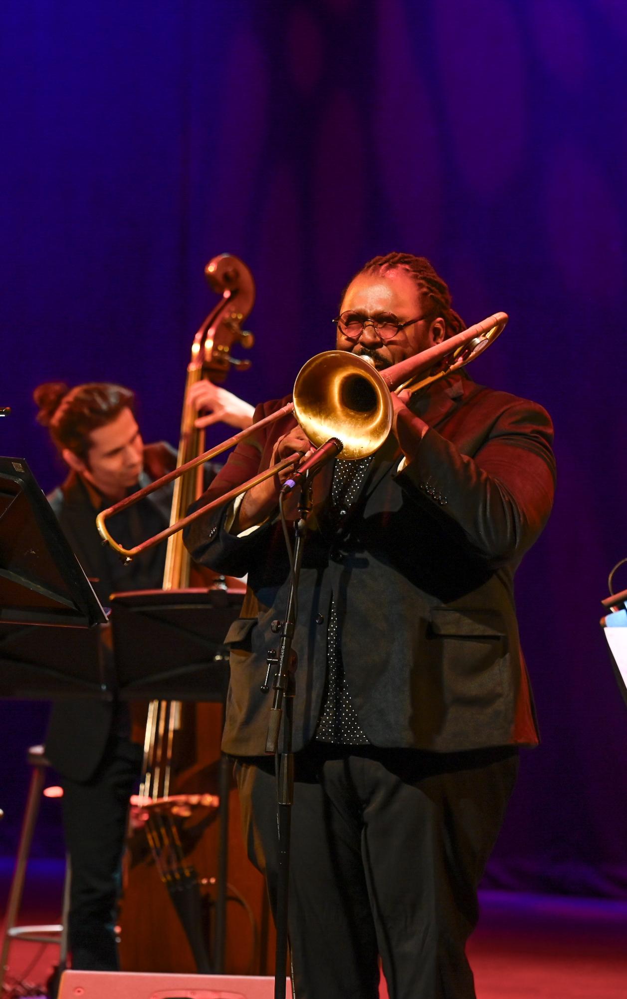 Trombonist Lamar Guillary shuts his eyes while executing a difficult sequence of notes during a solo. After the performance, students approached him and other members of the quintet to get autographs and ask questions.