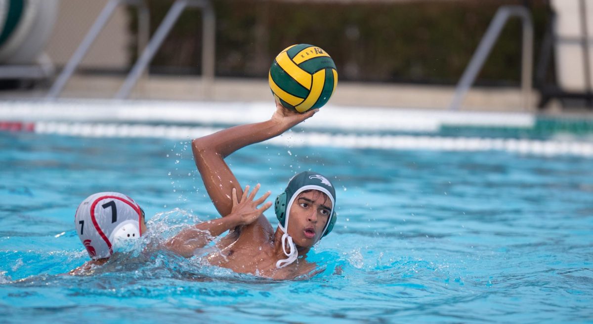 Adithya Sathyanarayanan (10) holds the ball away from his opponent to prepare for a pass. He made multiple steals against Gunn attackers, contributing to the Eagles' defense.