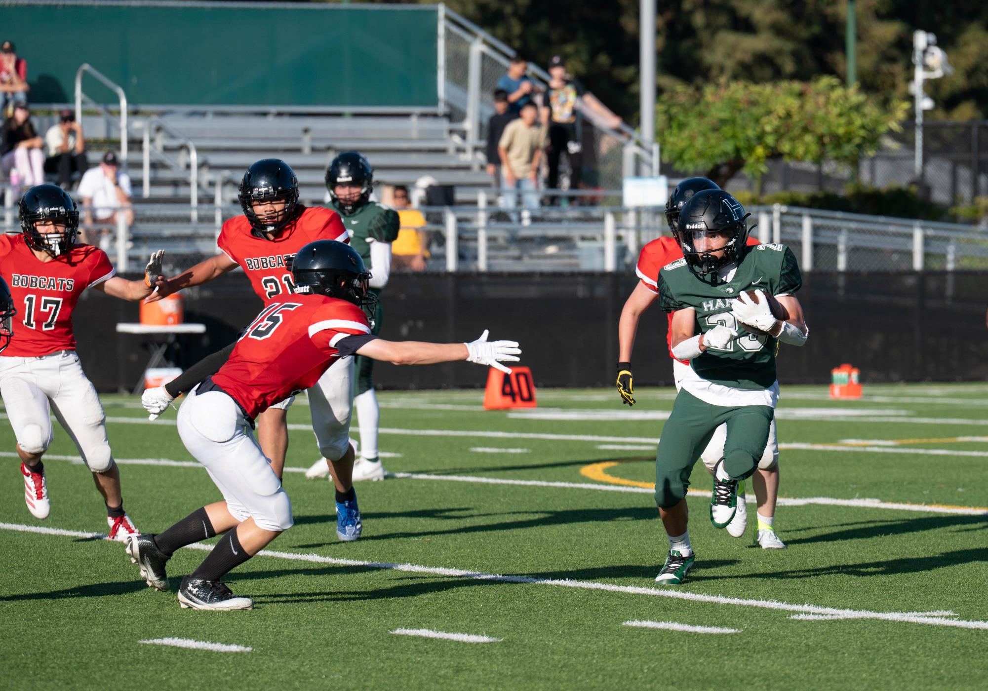 Running back Pedro Castro III (11) takes the ball from a handoff and runs at BASIS defenders. During the match, Pedro gained a total of 142 yards in 10 carries.  