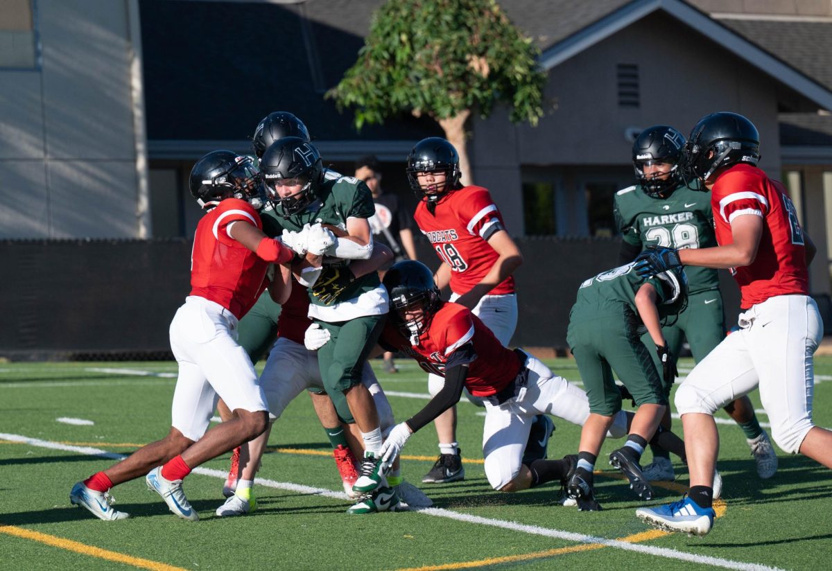 Running back Jackson Powell (12) charges at a defender five yards outside of the BASIS endzone. Alongside putting in numerous tackles, Jackson also gained 174 rushing yards for the team.