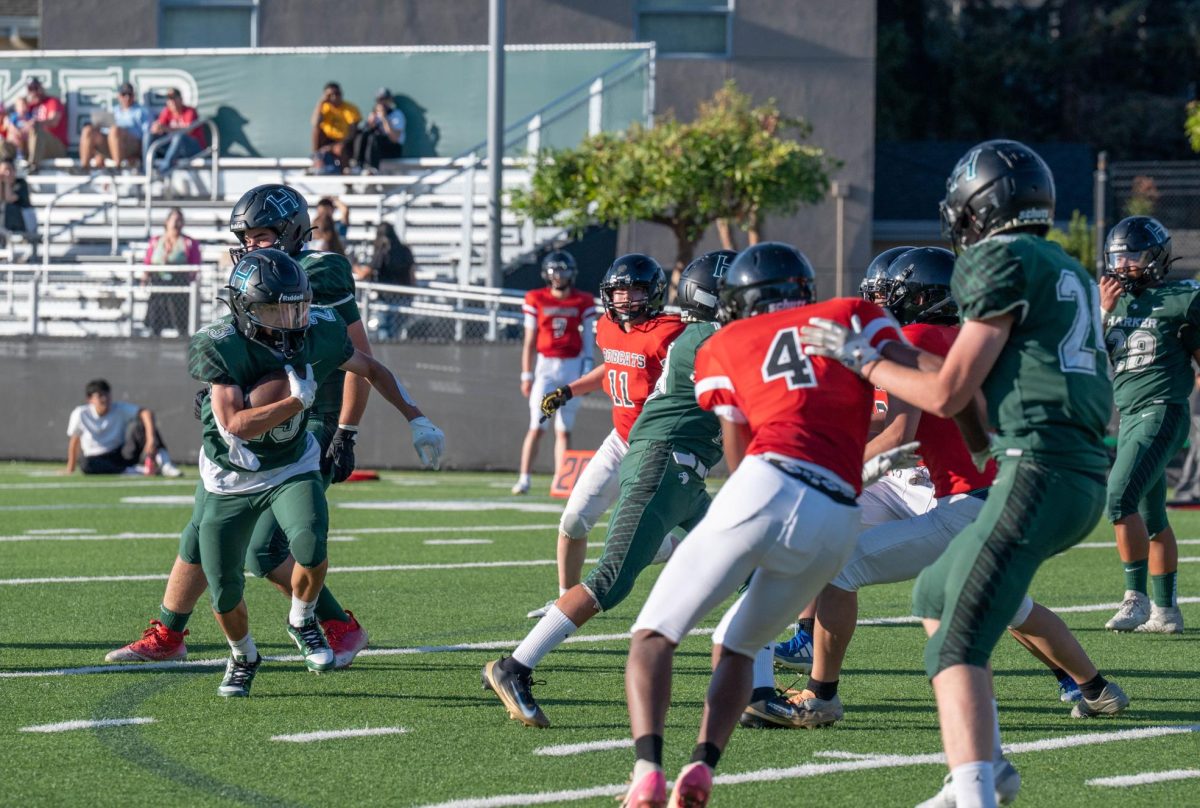Running back Pedro Castro III (11) sprints at the BASIS endzone for a conversion in the second quarter. He scored four conversions during the team's season opener.  