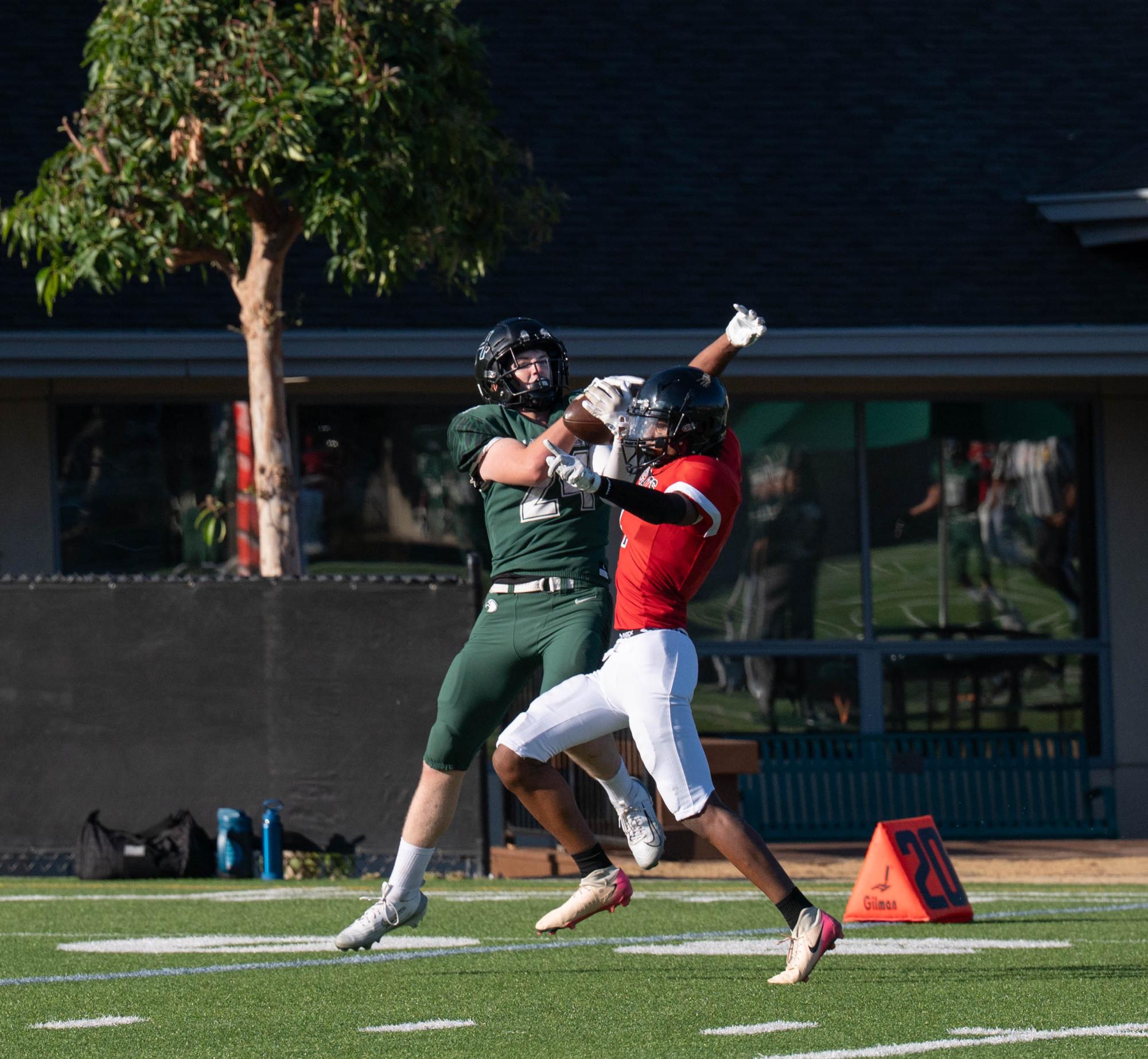 Wide receiver Mason Brooks (11) leaps into the air to catch the ball. Mason caught a 30-yard pass from quarterback Ricardo Sanchez (10) in the first minute to his second touchdown.