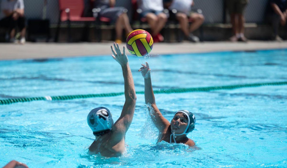 Bartu Milci (9) lobs the ball over an opposing player to find a teammate. Though temporarily injured at the start of the second half, he returned and created several key passes for teammates.