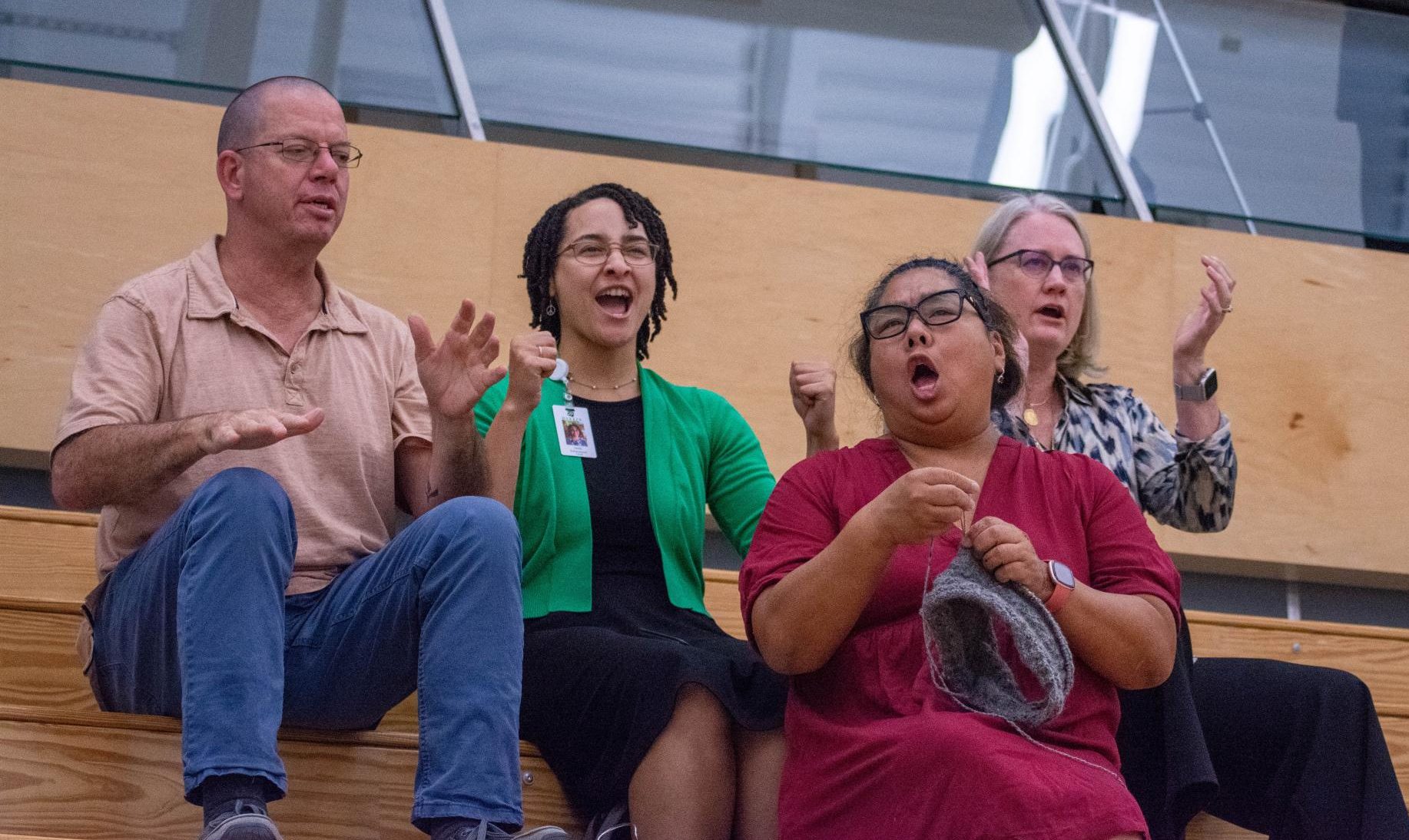Harker teachers cheer on the eagles from the sidelines. The eagles won the game in two sets, 26-24 25-22.