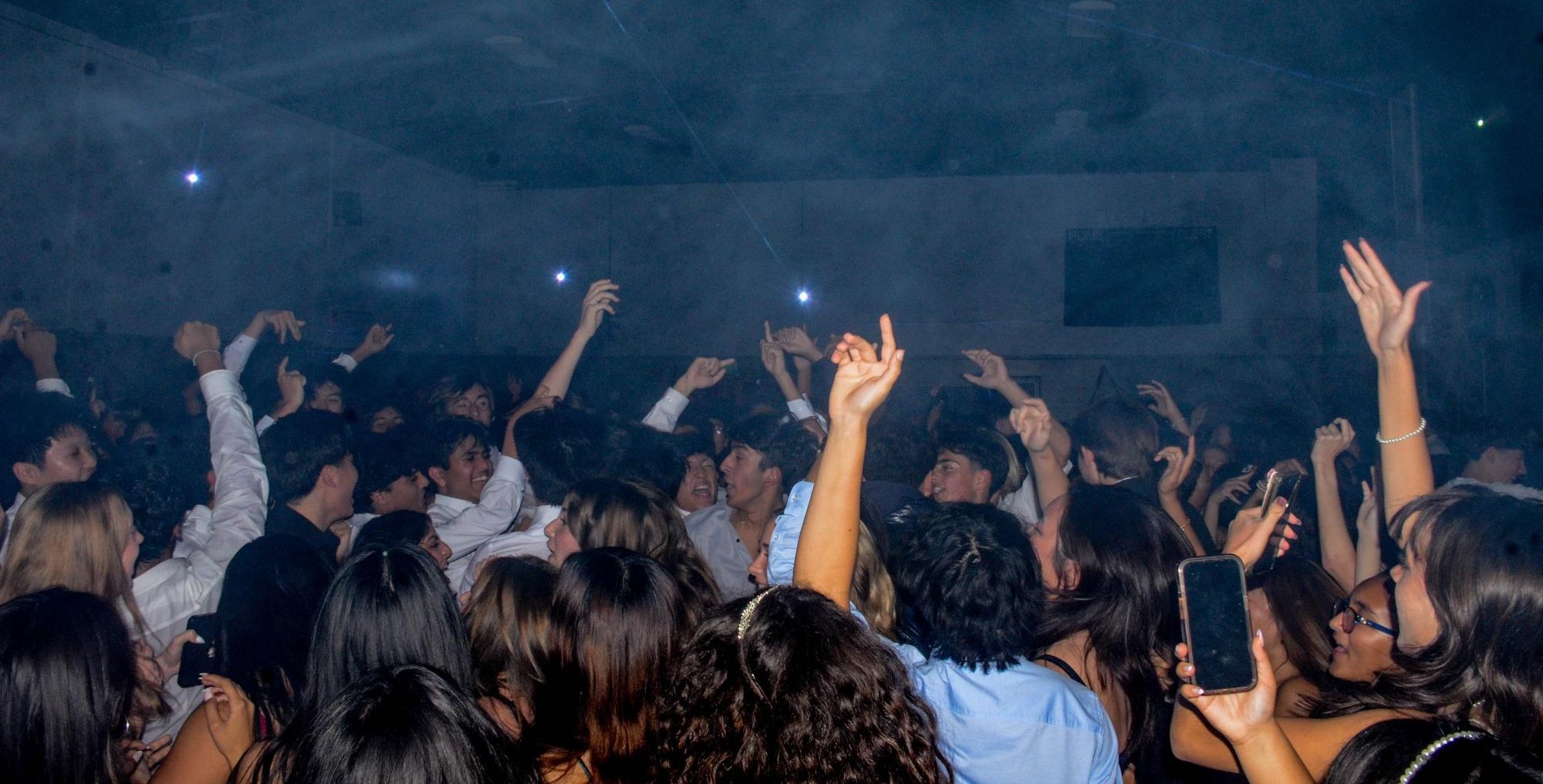 Students form a circle as they dance to a lively song. Throughout the night, the DJ would play upbeat music that hyped up the crowd of dancers.