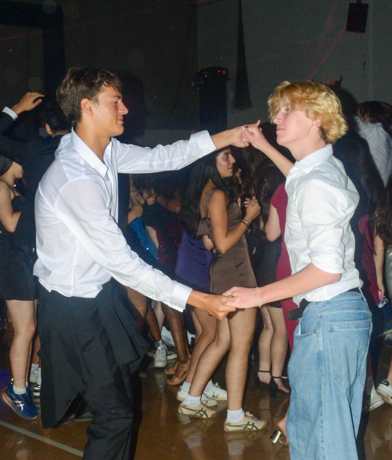 Senior Alejandro Cheline and sophomore Weston Smith share a lighthearted dance during a slow song together. The annual homecoming event brought hundreds of students to the gym for an evening of dancing and festivities.