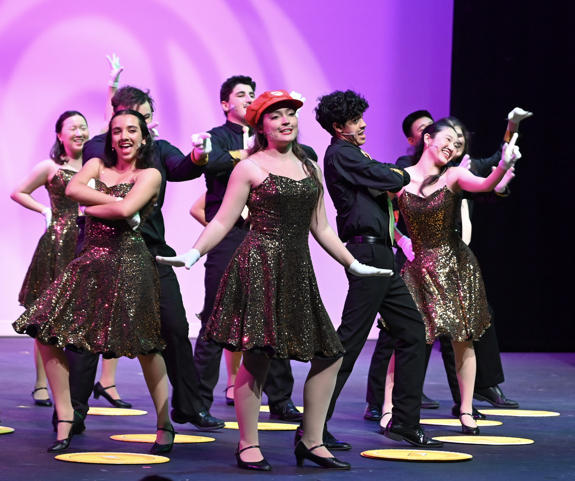 Downbeat poses at the end of their performance of “Jump Up, Super Star!” from Super Mario Odyssey. “The amount of effort that goes into putting on a show like this, where everyone's coming together is amazing,” Priya Mysore, parent of senior Downbeat member Ishan Mysore, said.