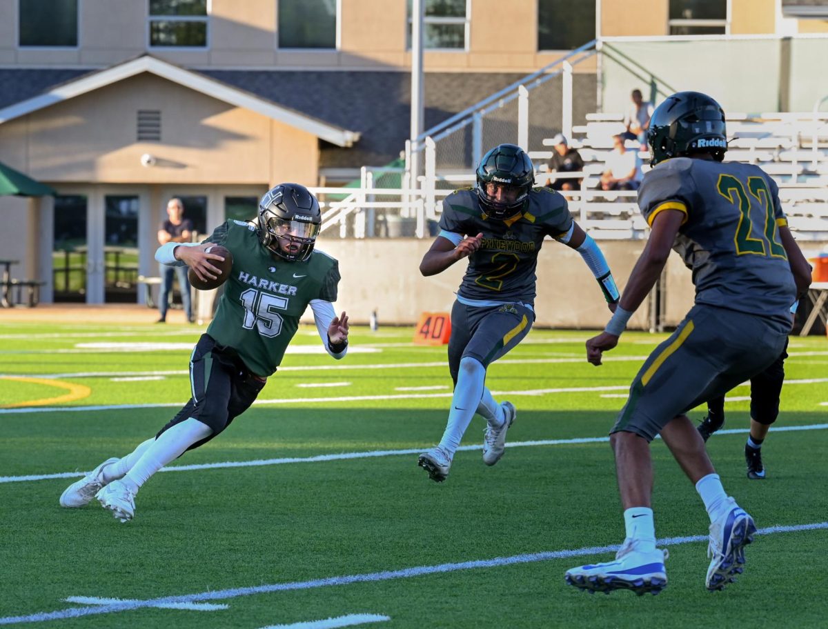 Quarterback Ricardo Sanchez (9) clutches the ball as he tries to get past two Pinewood defenders. Harker won the game 44-8.