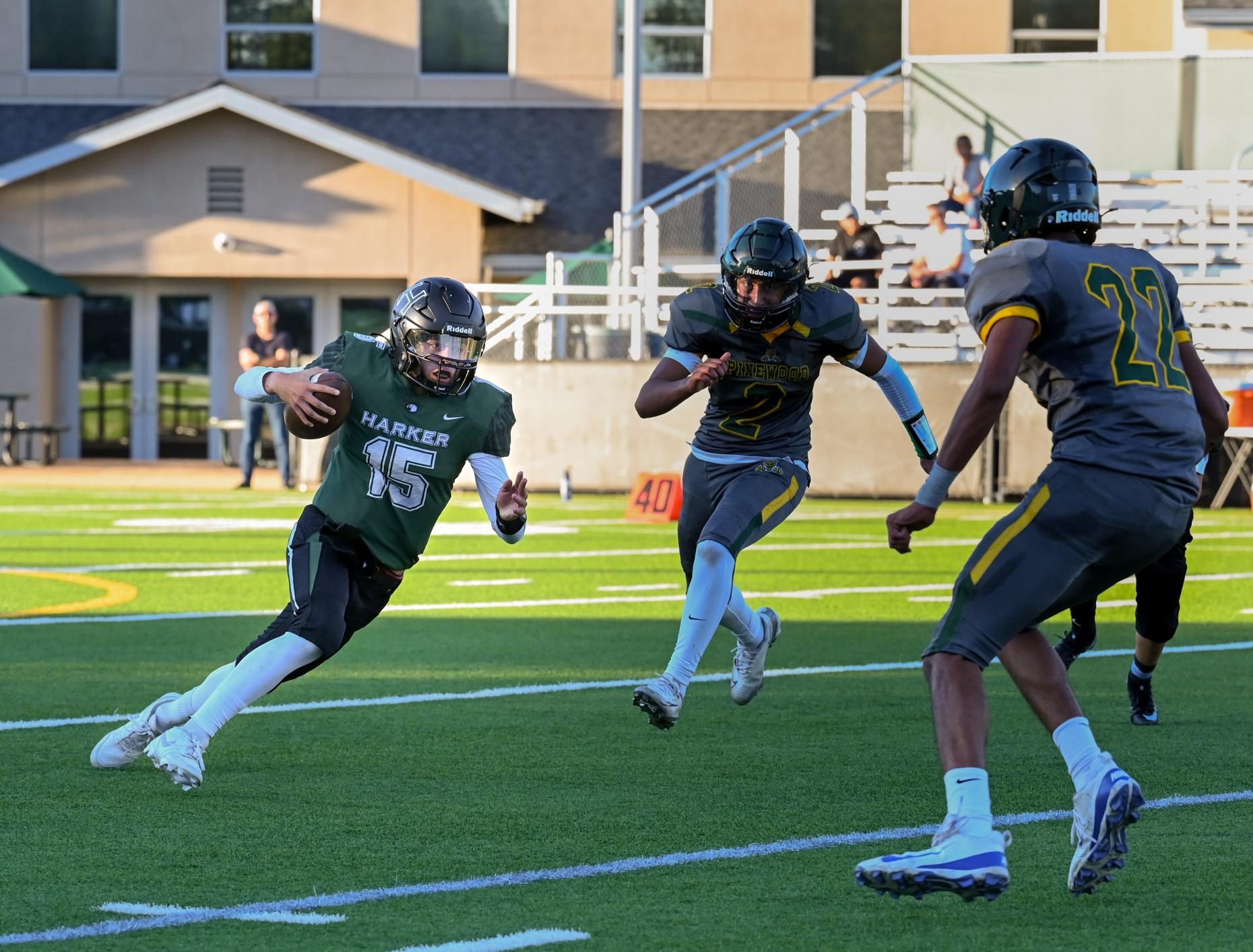 Quarterback Ricardo Sanchez (9) clutches the ball as he tries to get past two Pinewood defenders. Harker won the game 44-8.