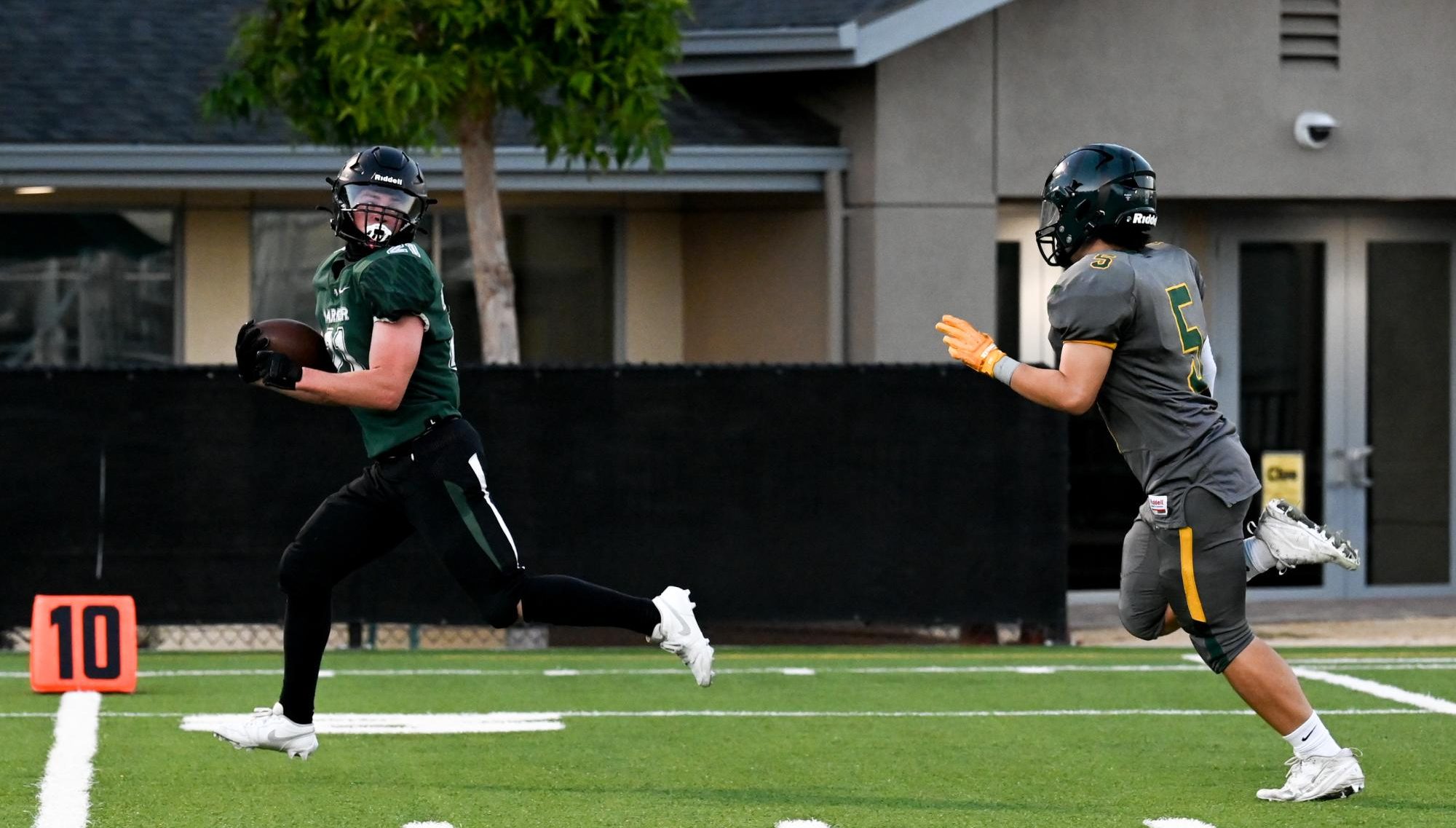 Running back Jackson Powell (12) looks back at a Pinewood defender as he runs toward the end zone. Before the game, a ceremony honored the football and cheerleading seniors.