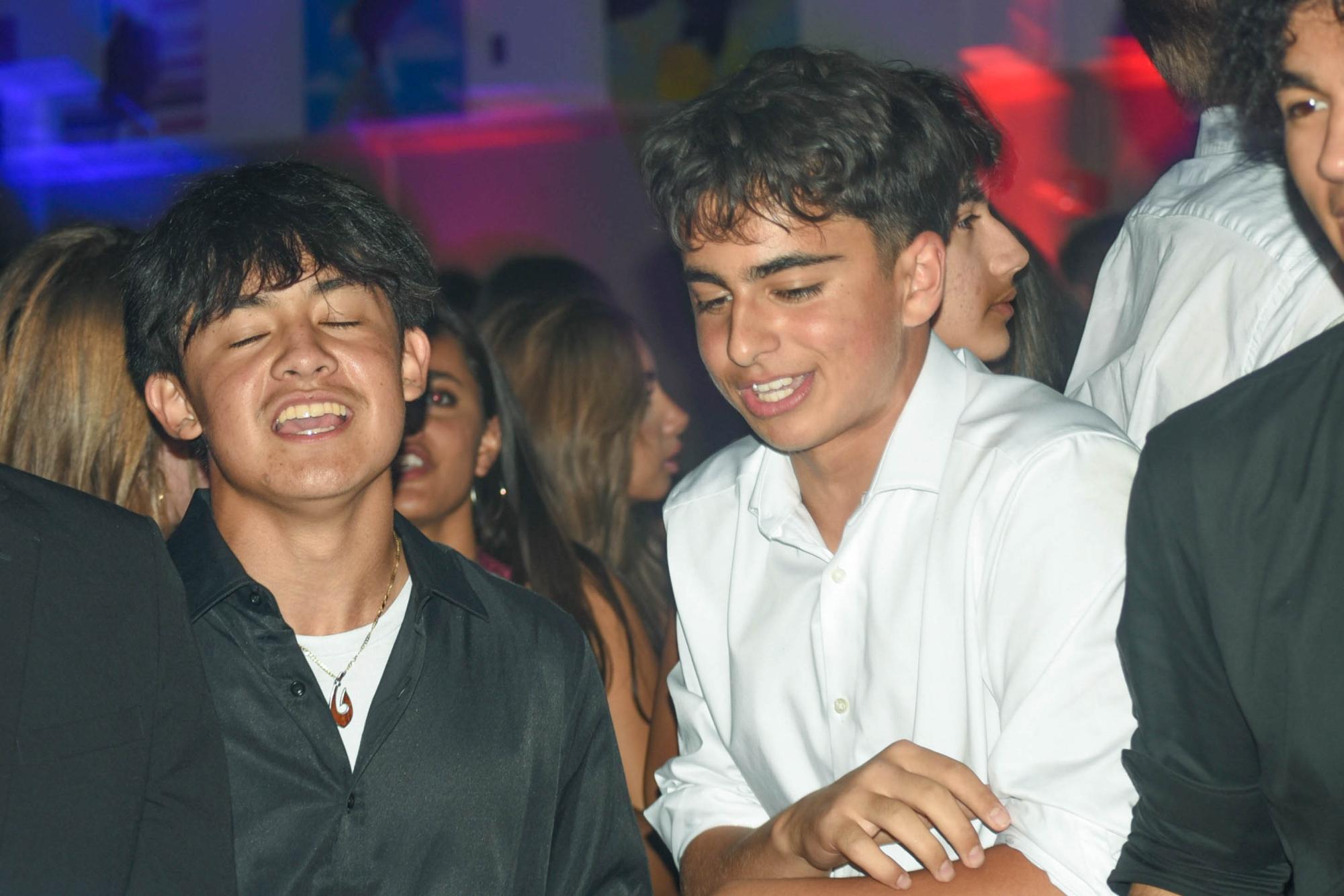 Mason Tamashiro (9) and Christian Mehta (10) share a conversation on the dance floor in Aux Gym. Students could leave the gym to take photobooth pictures, have refreshments outside, or play casino games in Mr. Hurshman's classrom.