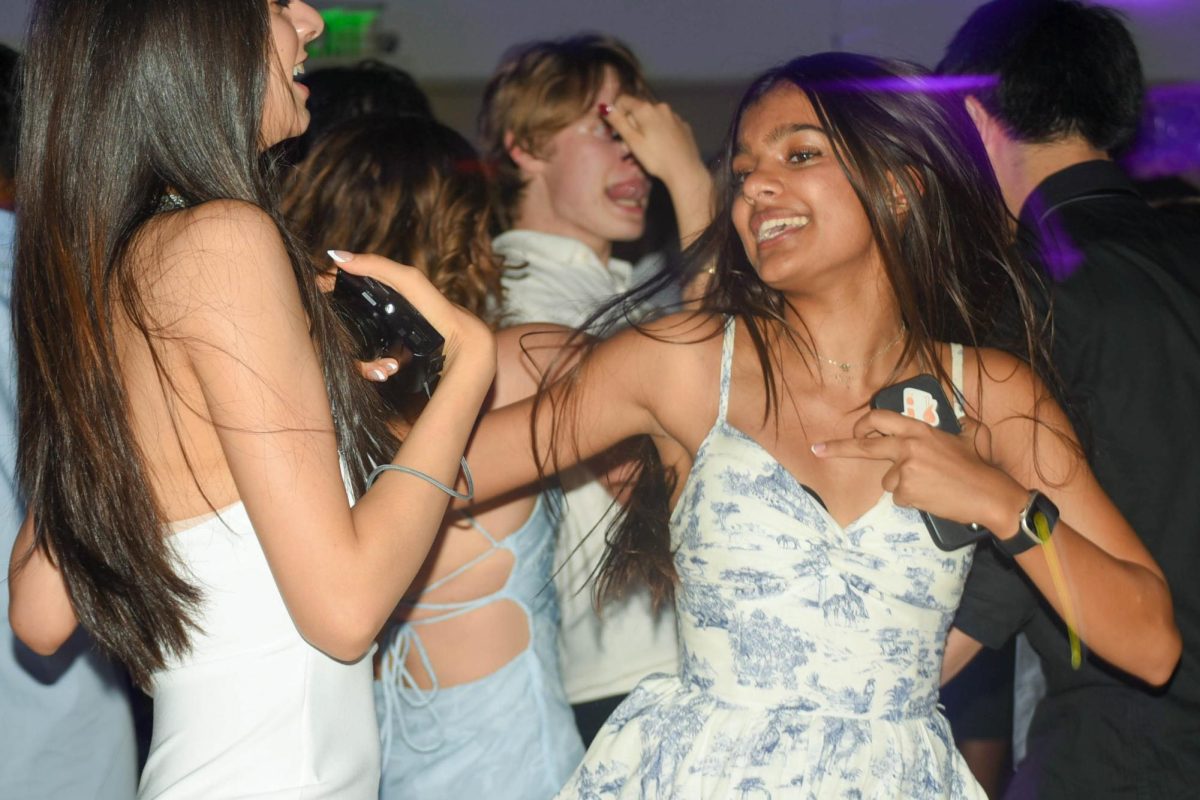 Samaara Patil (11) dances in the Vegas-themed Aux Gym during the Homecoming dance. Students submitted song requests through a Google Form prior to the event.