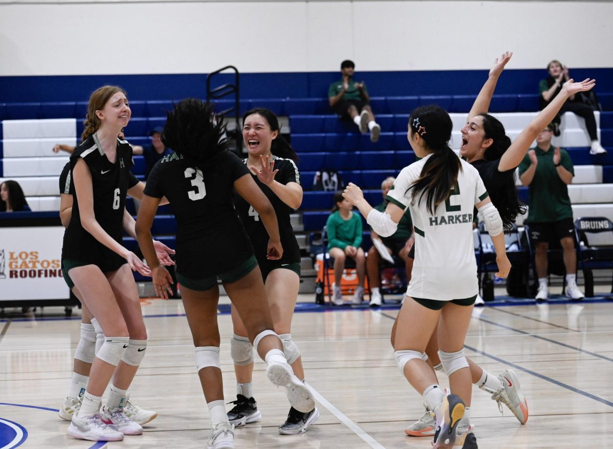 The varsity girls volleyball team celebrates a point scored in their last match against Branham High School on Aug. 28. The two teams will face off again on Davis Field this Saturday in lieu of the homecoming football game.
