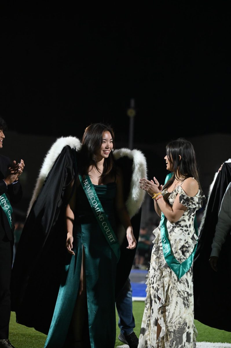 Senior Sophia Ou receives a cape as Homecoming queen. Her and senior Timothy Deng were voted queen and king in a school-wide Google Form.