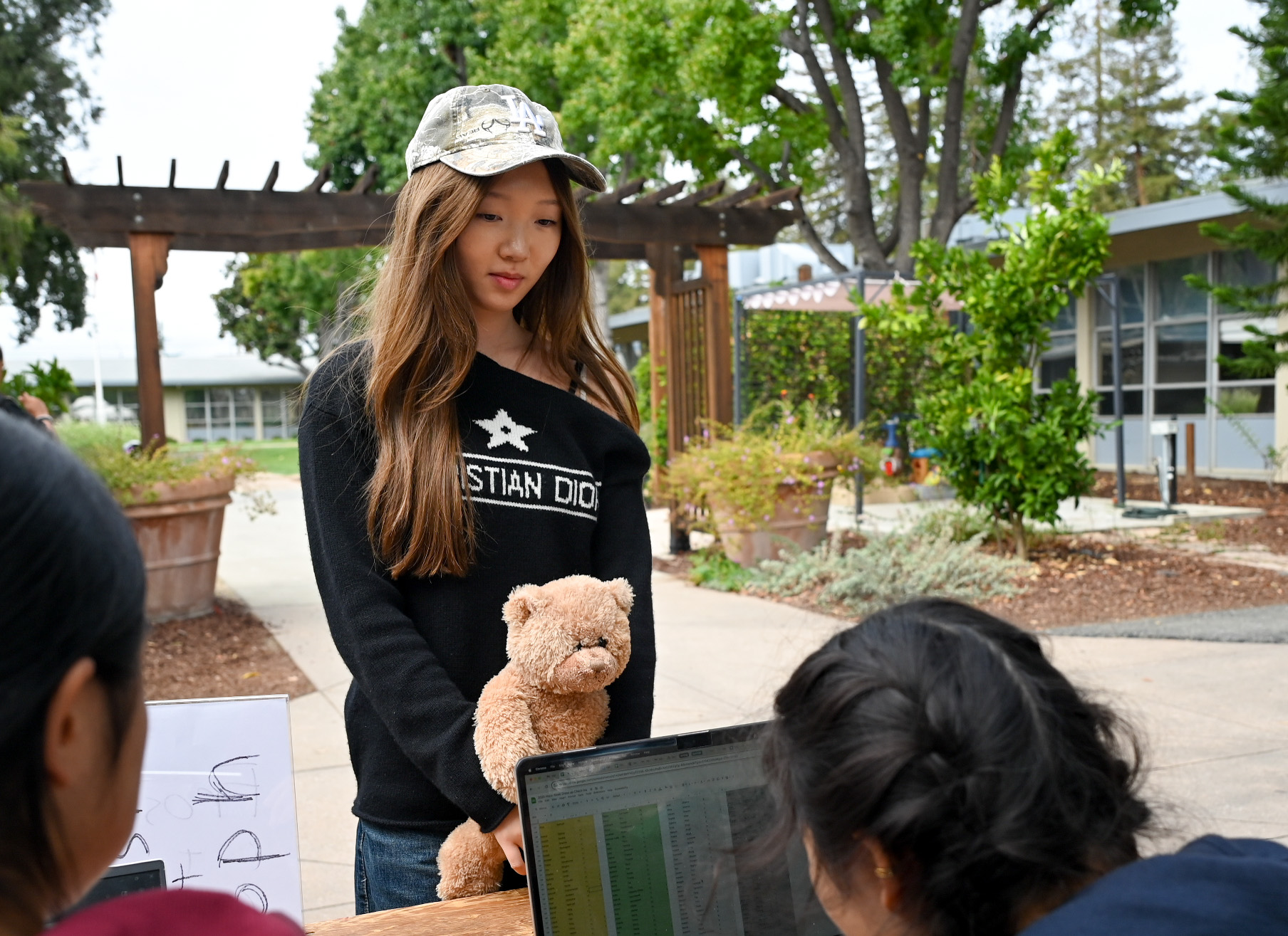 Junior Zoe Wang holds a stuffed teddy bear as she checks in for spirit points. Ensembles for the theme ranged from park rangers to grizzly bears.