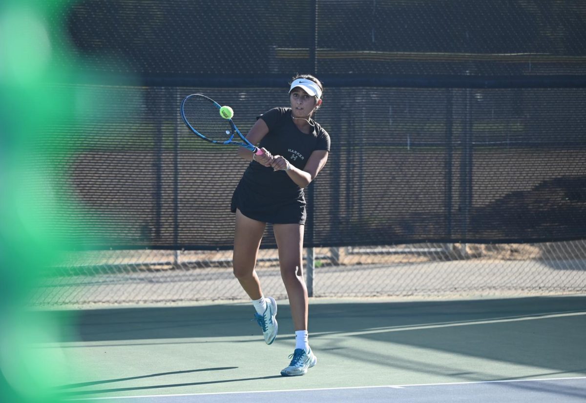First singles player Pavith Khara (12) swings at the ball. She suffered from a back injury, so she was unable to play a second match.