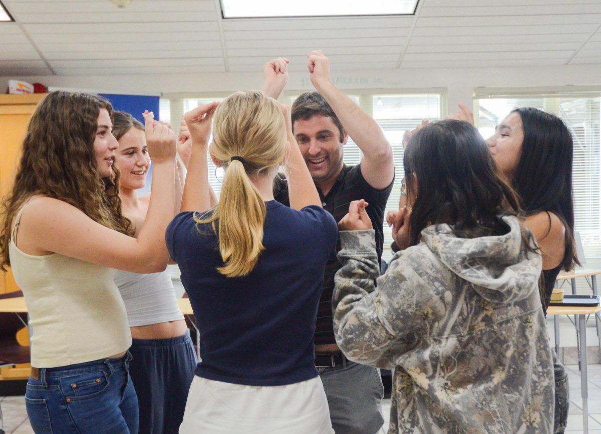 Economics teacher Samuel Lepler dances to traditional Jewish music at the Jewish Affinity Group celebration of Rosh Hashanah.  Attendees also ate Jewish food and played trivia.