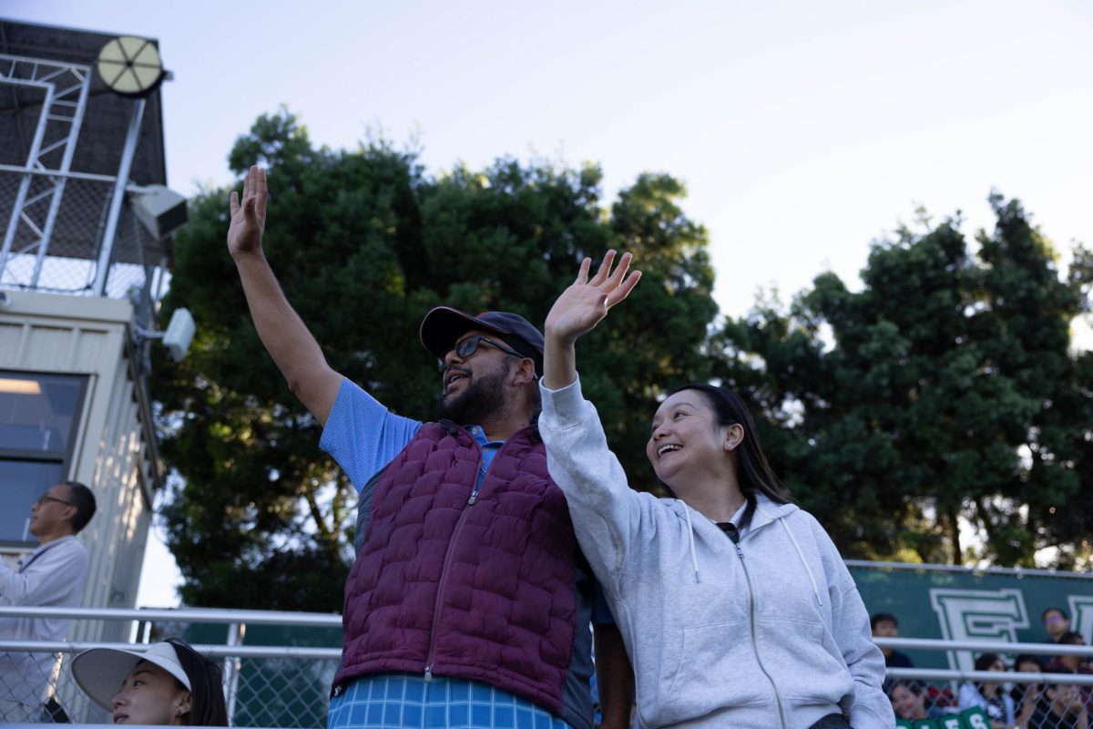 Parents wave as spectators fill the stands. The homecoming pre-game festivities began at 5:30.