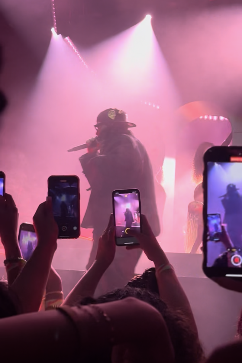 Concertgoers hold up their phones to record singer PARTYNEXTDOOR. “Filming detracts from happiness,” junior Laya Sunkara said. “You're not focusing on this thing that you've been so excited about, and you're not focusing on those emotions and absorbing them while they're lasting.