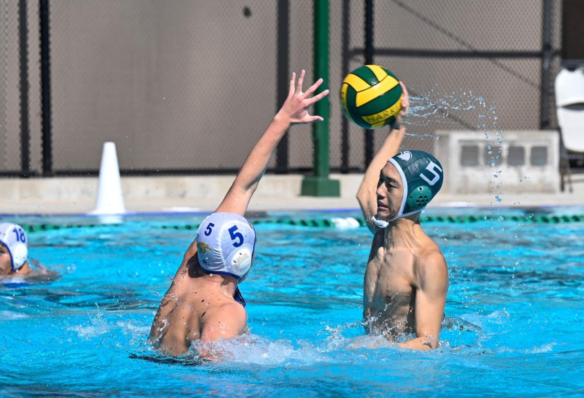 Driver David Tang (11) surges out of the water for a powerful shot. David was a key piece in the Eagles' offense, scoring two of their goals and setting up several plays with his passing.