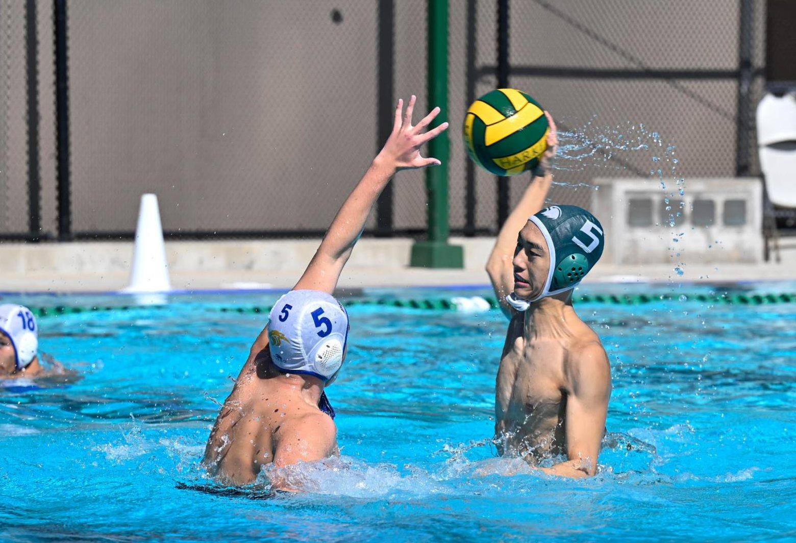 Driver David Tang (11) surges out of the water for a powerful shot. David was a key piece in the Eagles' offense, scoring two of their goals and setting up several plays with his passing.