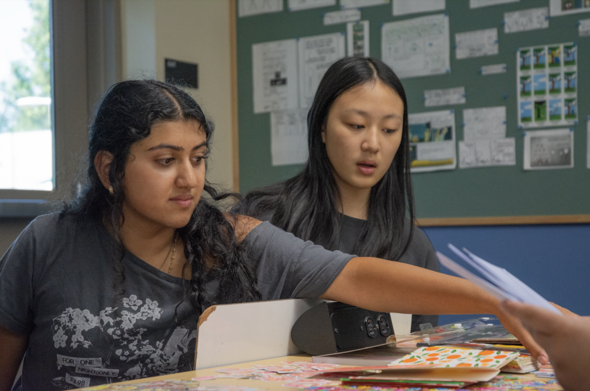 Sophomores Mehr Paul and Grace Yao choose supplies for their cards. Officers prepared a wide selection of colorful, patterned envelopes, cards and stickers for attendees.