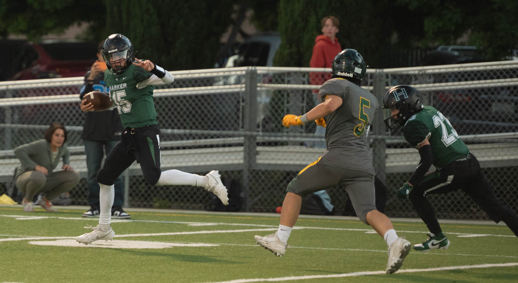 Quarterback Ricardo Sanchez flashes a peace sign as he speeds past a Pinewood defender. The referees called back Ricardo's second scrambling touchdown due to Taunting.