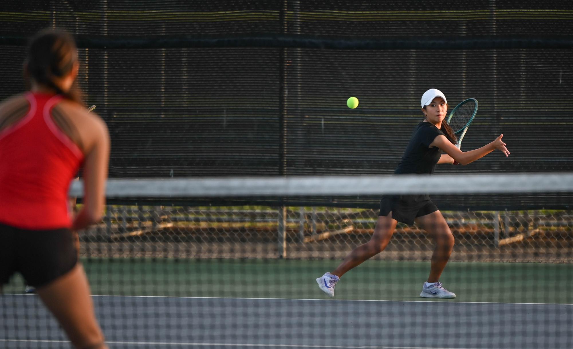 Doubles player Alyssa Lee (9) aims for the ball. Alyssa and her partner Claire Xu (11) won their matches 6-0, 6-2.