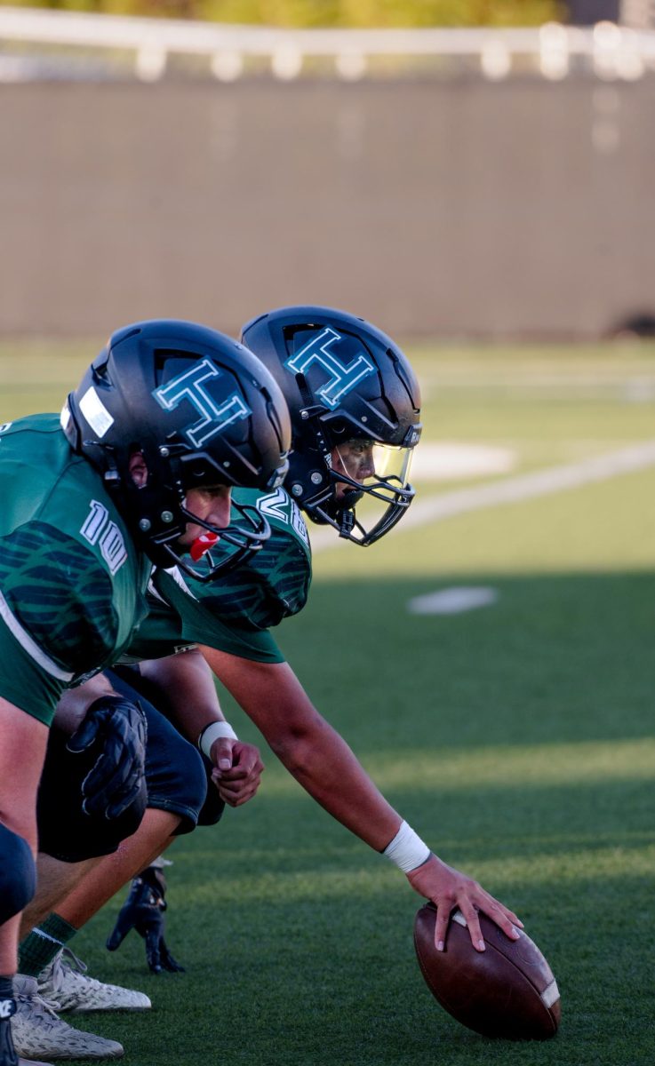 Varsity football player Marloe Sanchez-Taporco (10) prepares to snap the ball during their tailgate game against Pinewood. He made crucial tackles that aided the Eagles' victory 44-8.