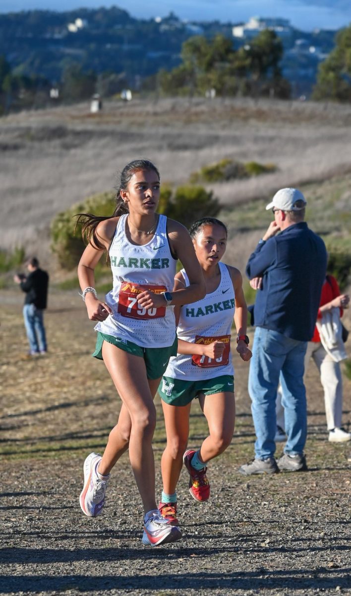 Varsity cross country runners Samaara Patil (11) and Ava Alvarez (11) run at the WBAL finals. They placed seventh and eighth, allowing the girls team to qualify for CCS Championships.