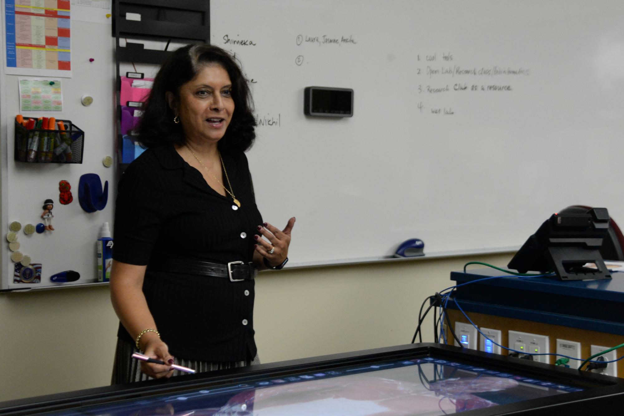 Human Anatomy and Physiology teacher Anita Chetty explains the body of "Carl" on the anatomy table. The expensive piece of equipment features rotatable 3D models of real people who donated their bodies to science.