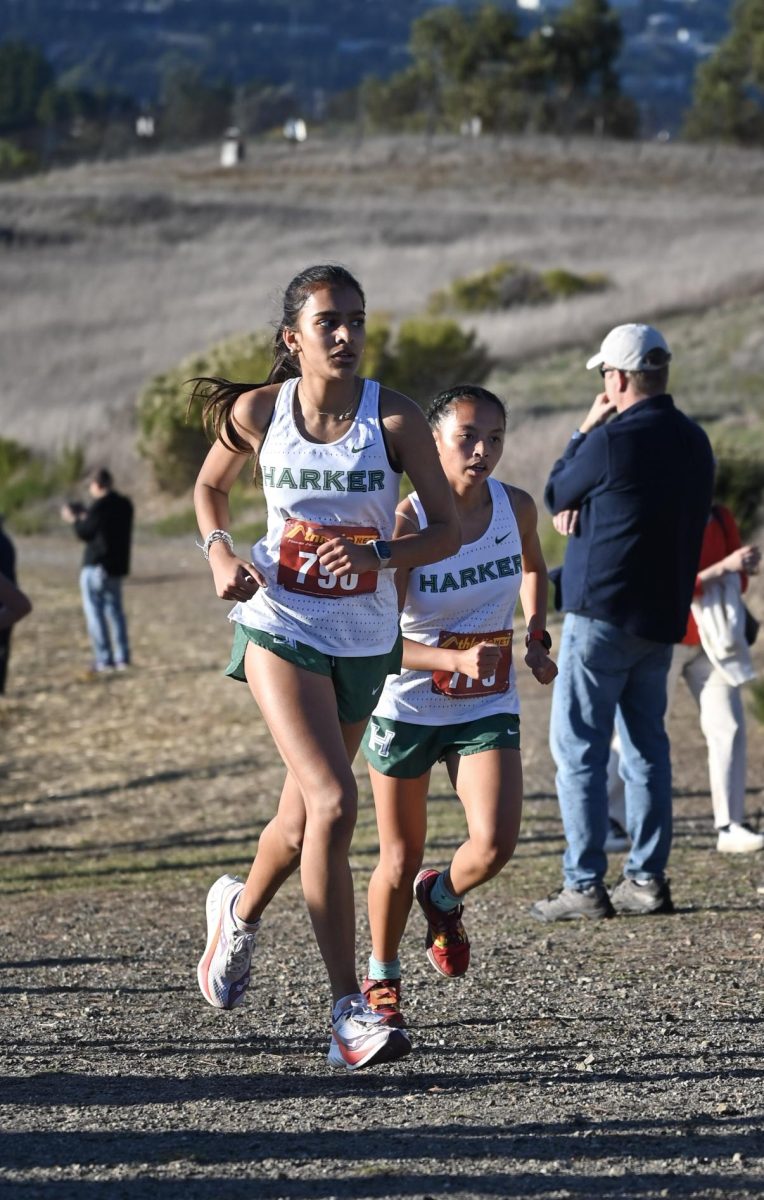Juniors Samaara Patil and Ava Alvarez run side by side during their race. Varsity girls raced last, and the team placed second overall.
