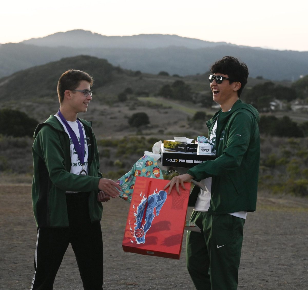 Senior Robinson Xiang laughs as junior Axel Szolusha hands him his senior night gifts. “It feels like I was just a freshman yesterday watching the seniors graduate and get their gifts,” Robinson said. “Now it's crazy how I'm the one getting the gifts, and I'm just so grateful for everything."