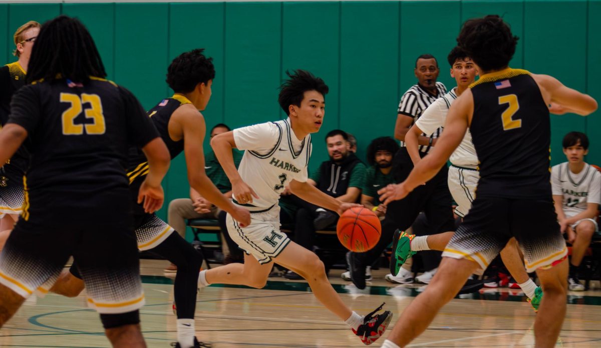 Guard and captain Caden Ruan (12) splits a group of Del Mar players as he drives to the basket. Caden's 16 points were second only to guard and captain Lucas Huang (10).