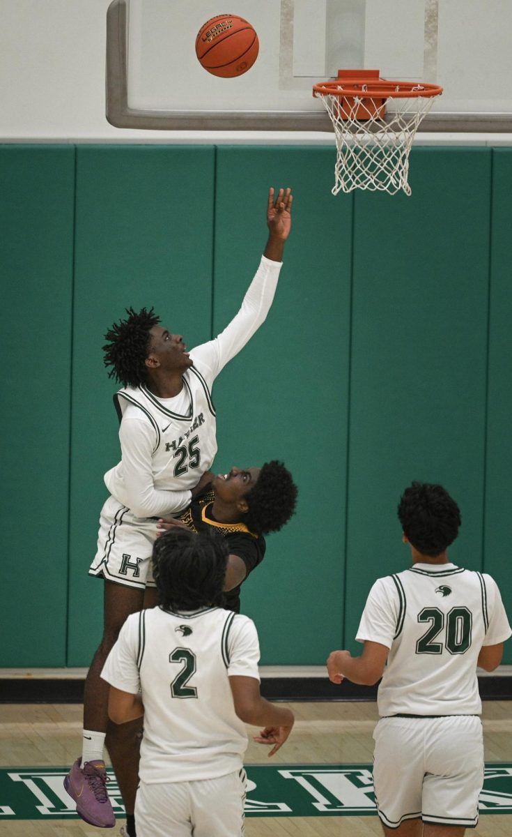 Forward Babila Mfonfu (11) rises from the baseline for a rim attempt. Throughout the game, Babila drew fouls as he attacked the paint with his speed.