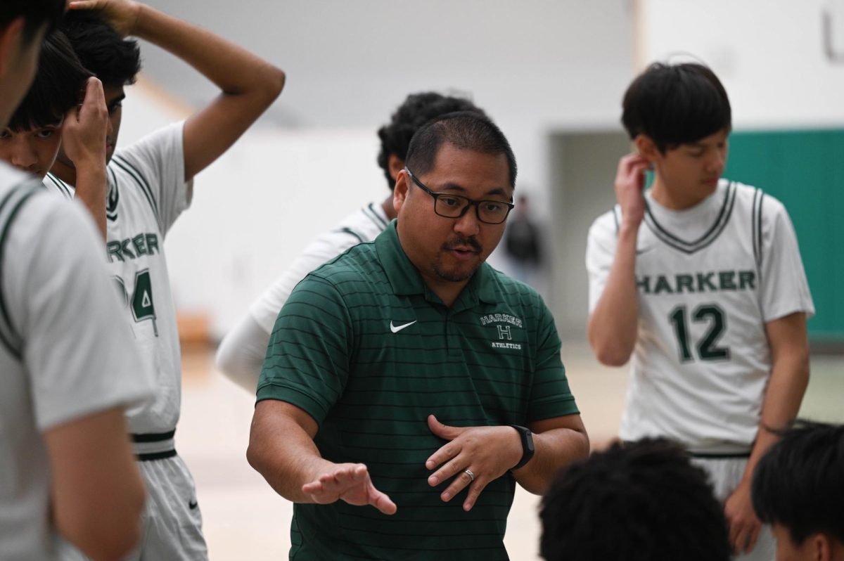 Head Coach Alfredo Alves goes over defensive strategy after the first quarter. Using full court press, the Eagles made it difficult for Del Mar to advance through halfcourt.