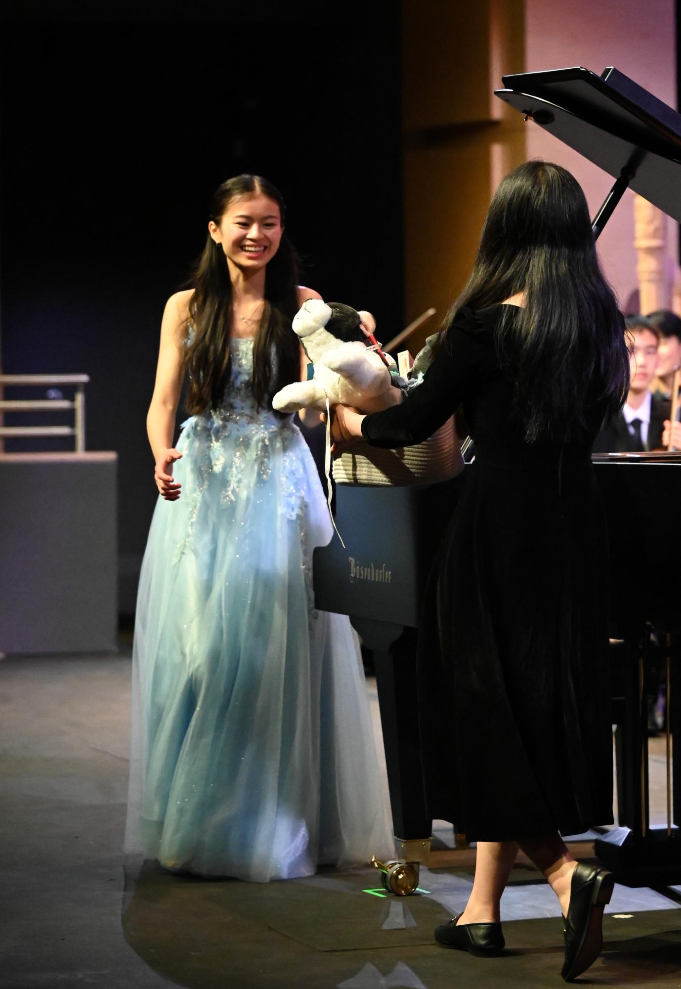 Fellow pianist and percussionist junior Vivian Wu (11) presents Mindy with a stuffed animal. "I’ve associated this piece with Mindy since the day I met her," Vivian said. "she was practicing it then, and over time, it has truly become her piece."
