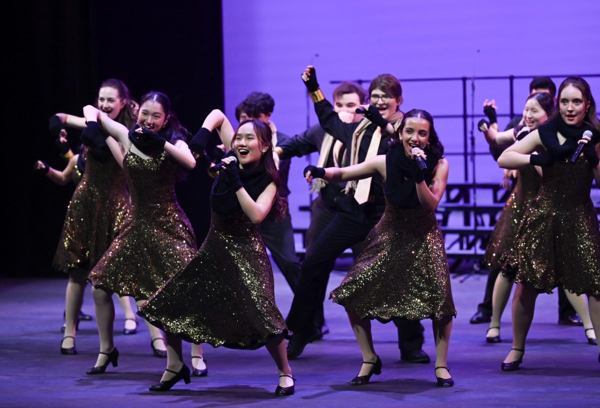 Downbeat members Jessica Skylar Chen (11) and Megha Unny (11) groove while performing “Don’t You Worry About A Thing.” Downbeat performed twice in the Big Assembly Day show.
