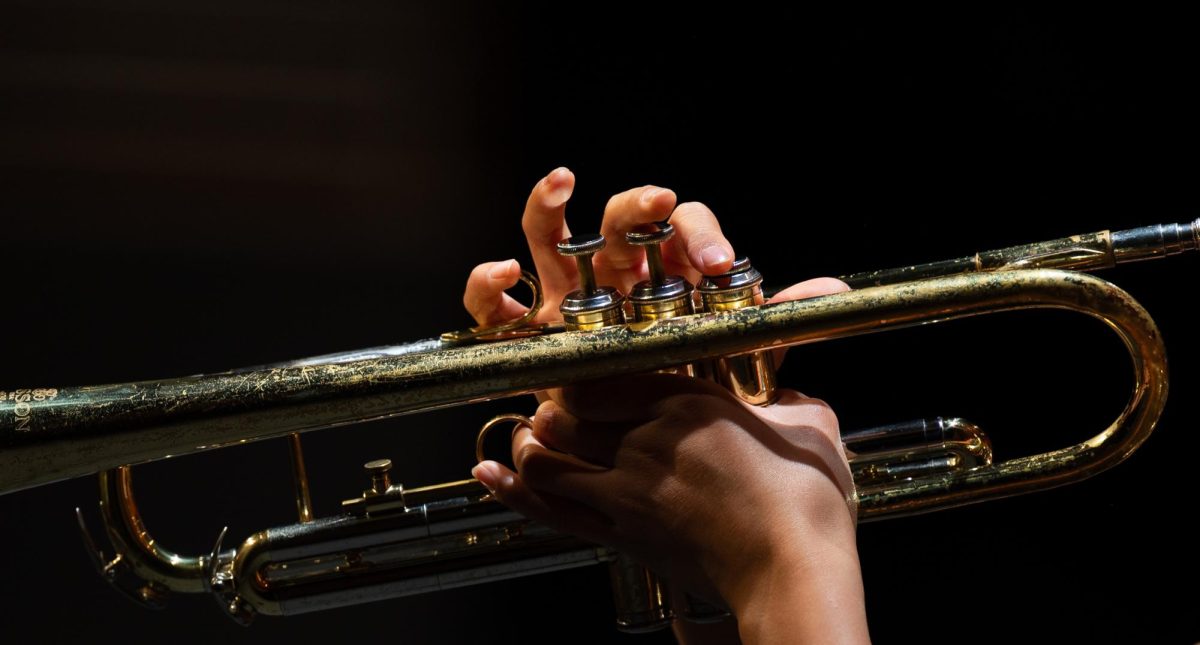 Trumpeter Ava Alvarez (11) delivers her solo during "R U Chicken" by Kris Berg. Composed in 2012, the piece had a funky, irregular groove to it which the audience enjoyed right before intermission.