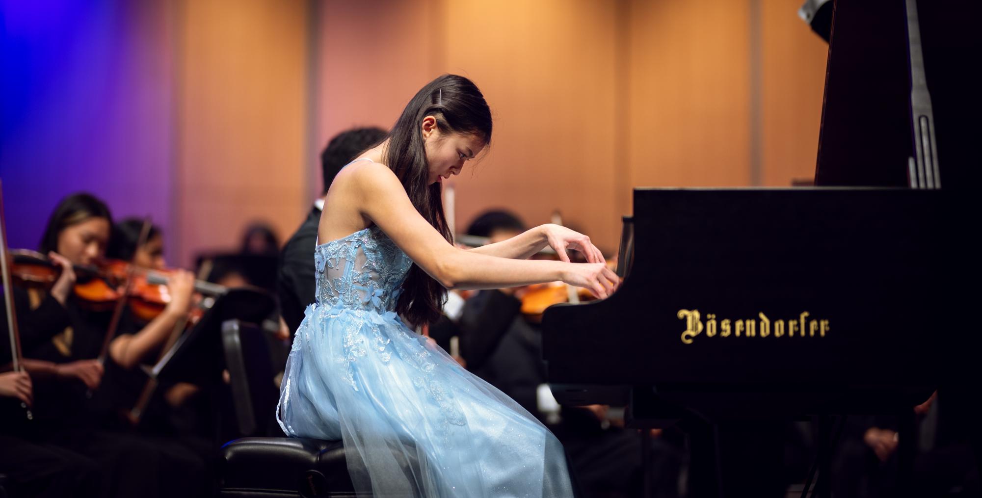 Senior concerto competition winner and soloist Mindy Truong (12) descends into the fiery coda of Rachmaninoff's Piano Concerto No. 2, Movement 3. "Seeing everyone there, seeing the orchestra, and hearing it all come together and seeing the audience, it made it feel very real and made me incredibly happy," Mindy said.