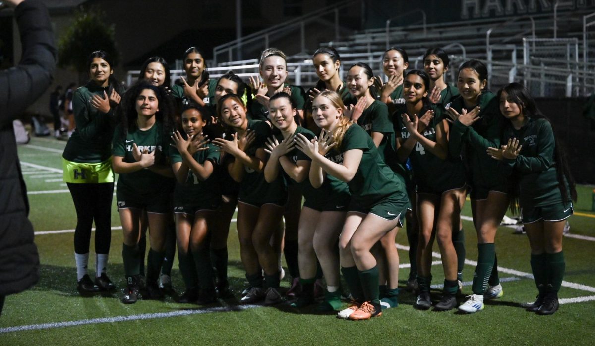 Varsity girls soccer team forms eagles with their hands after the game. Every player on the team received playing time during this game.