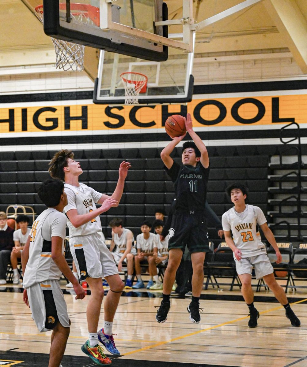 Guard Ethan Xu (9) rises up for a midrange jumper early in the first quarter. Ethan made the second field goal for the Eagles, bringing the score to 5-12.