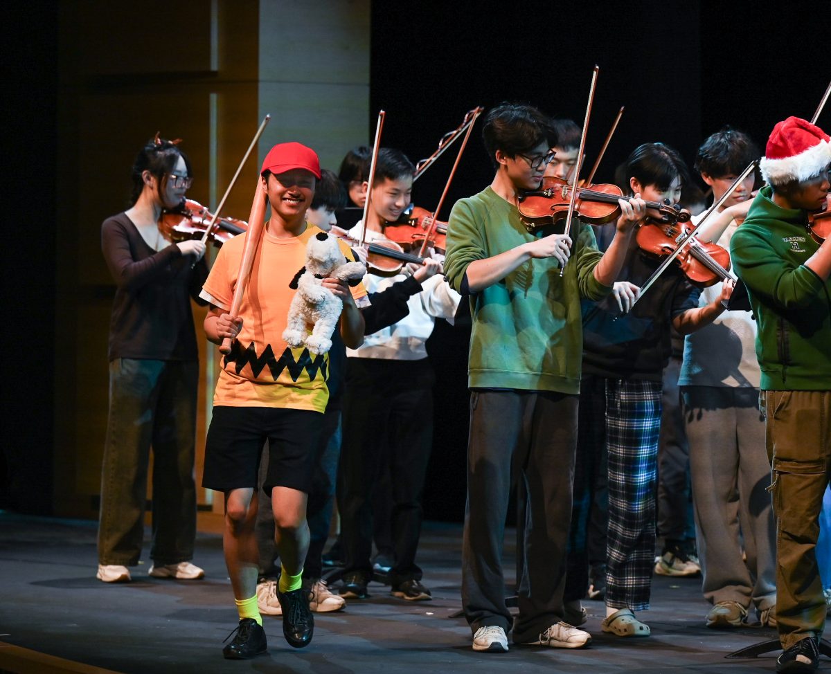 Orchestra director Jaco Wong makes a special appearance on stage dressed as Charlie Brown. The upper school orchestra and jazz band performed their annual rendition of "Sleigh Ride."