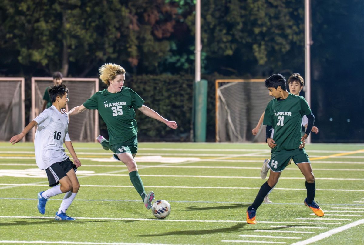 Defender Weston Smith (10) raises his leg to clear the ball after winning possession from a Piedmont Hills player. Weston supported Harker's backline by making several key tackles inside Harker's half.