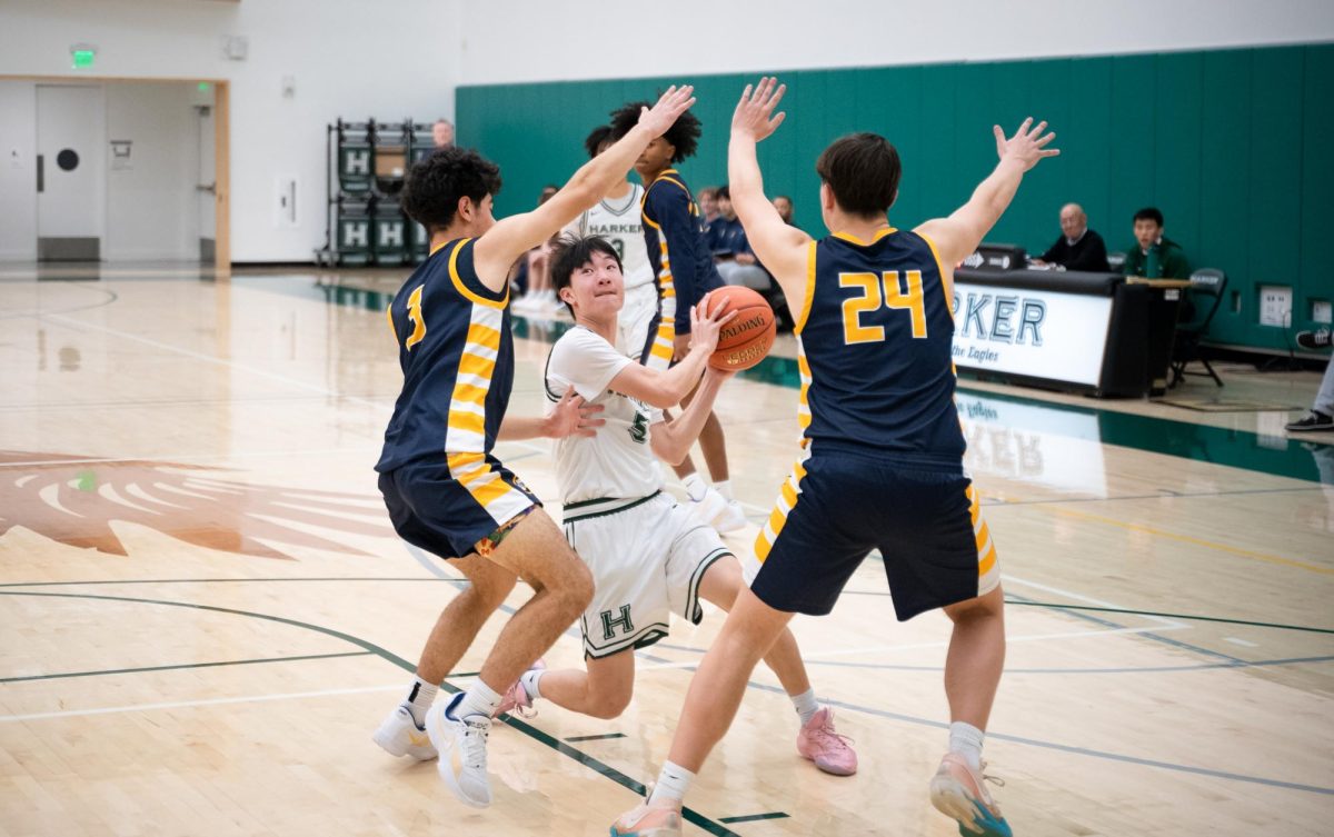 Point guard Stephen Gao (9) executes a slow step to throw off the rhythm of two Menlo defenders. Stephen shot 2 for 4 from the field and added on 3 free throws.