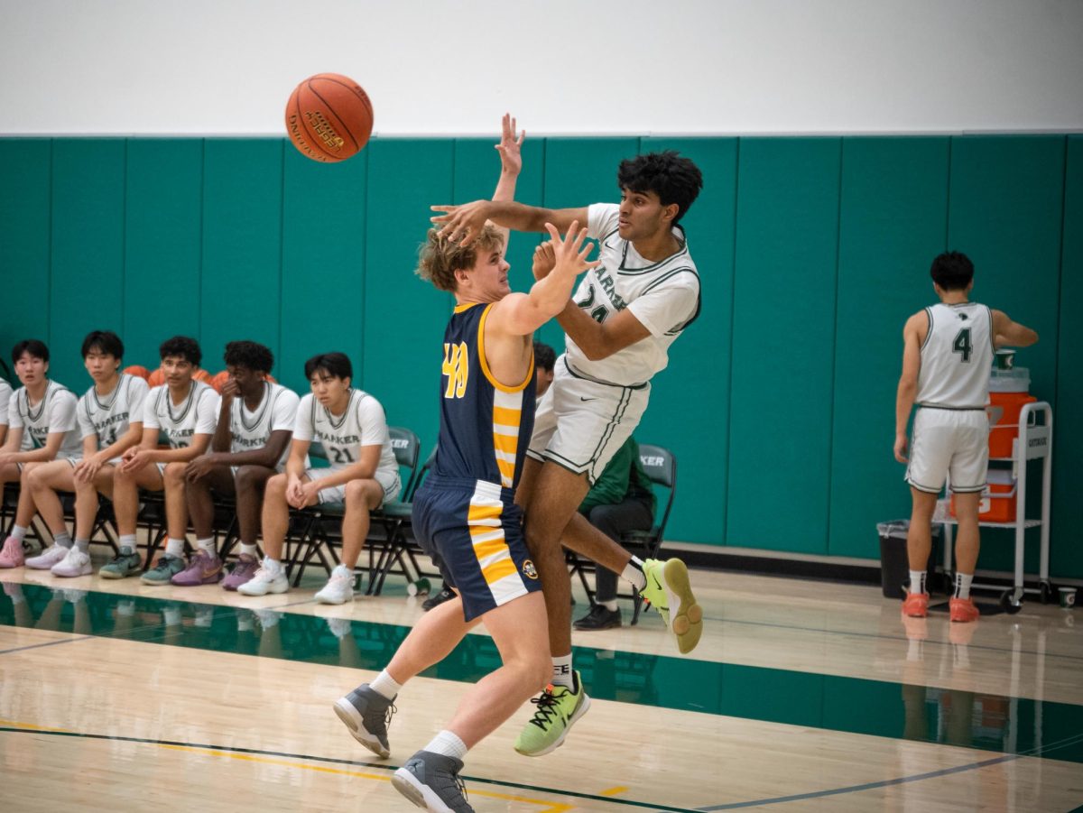 Center Vivek Yella (12) hurls a pass to a cutting teammate. All night long, the Eagles experimented with different offensive sets to work around Menlo's tall, physical defense.