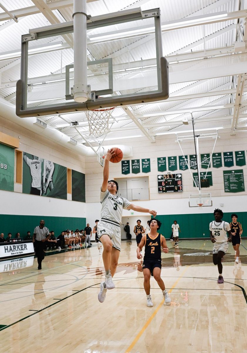 Point guard Caden Ruan (12) scores off of a fast break with less than a minute left in the quarter. He stole the ball from the Menlo point guard, securing his first points of the game.