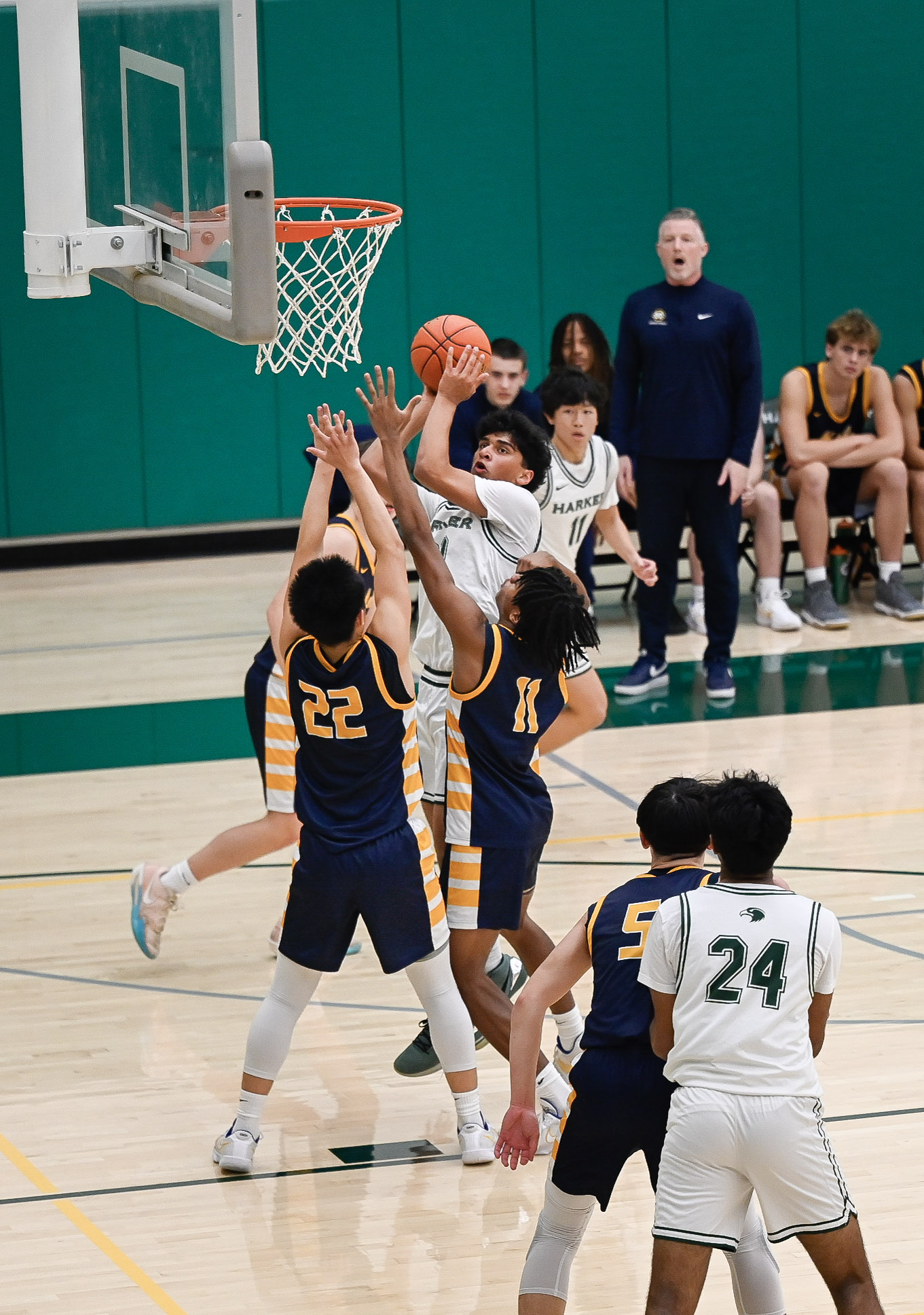 Forward Prithvi Pandey (9) rises up over Menlo defenders to put the ball through the hoop. Prithvi contributed multiple times in defense as well with multiple rebounds to allow the team to reset.