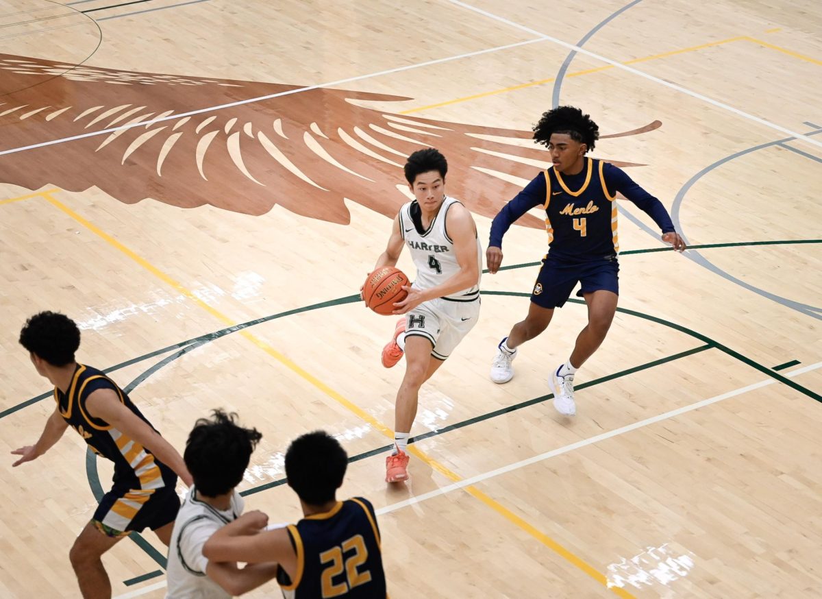 Shooting guard Lucas Huang (10) drives the ball to the basket. Scoring nine points, Lucas held the most points on the team in this game.